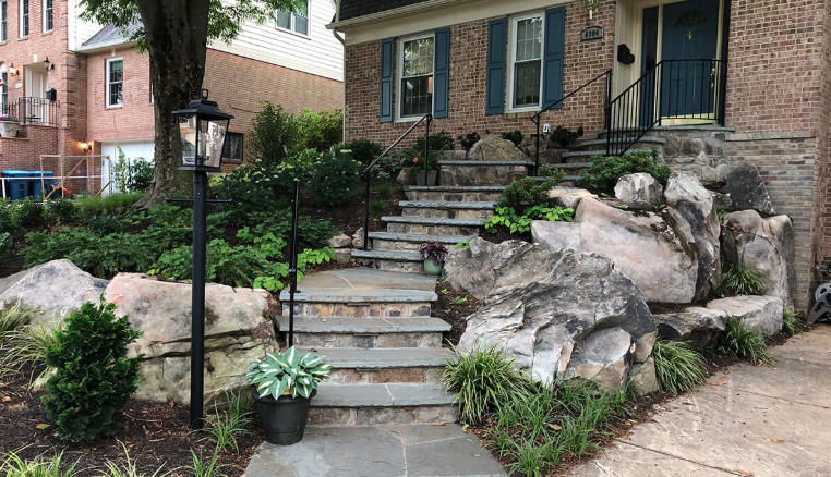 Front yard with natural stone walls